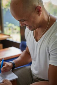 Man writing in mental health journal 